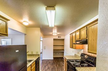 a kitchen with a stove top oven next to a refrigerator
